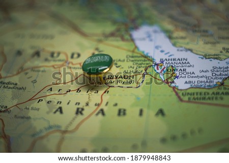Riyadh pinned on a map with the flag of Saudi Arabia