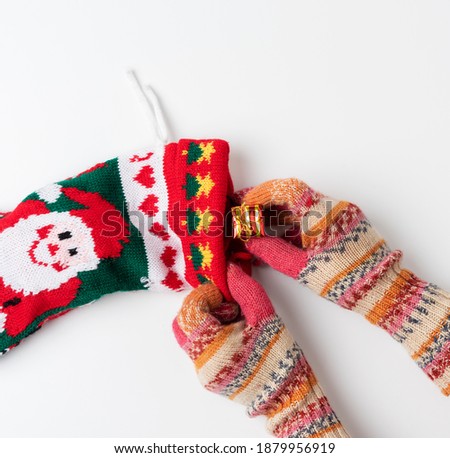 knitted brightly colored Christmas sock for gifts on a white background, holiday backdrop
