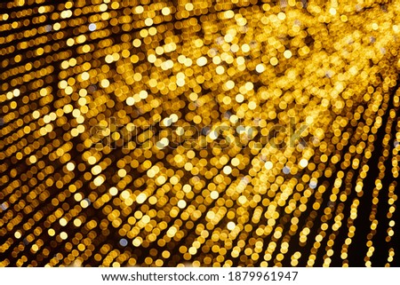 Many defocused christmas lights golden color texture.