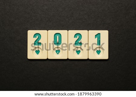 2021 new year symbol sequence lined with colored okey game stones on a black background