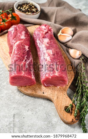 Raw pork fillet tenderloin. Fresh meat. gray background. Top view
