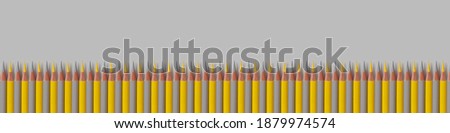Children's colored pencils in yellow and gray are arranged in a row. Concept trend of 2021.