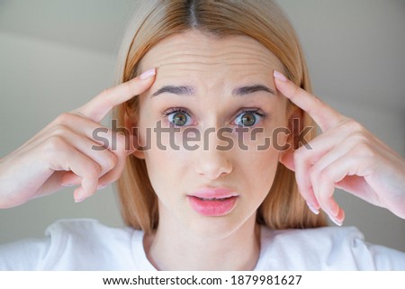 
A young girl has mimic wrinkles on her forehead Royalty-Free Stock Photo #1879981627