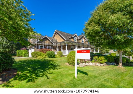 House for sale in Vancouver, Canada. Real estate sign in front of a house.