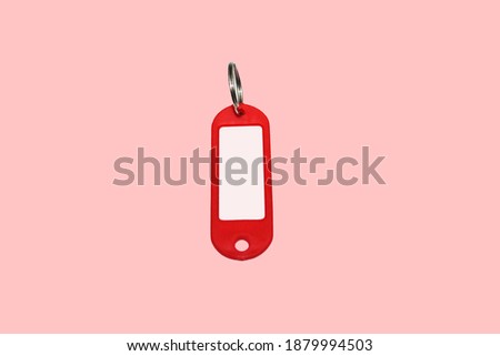 red plastic key ring or key chain on pink background 