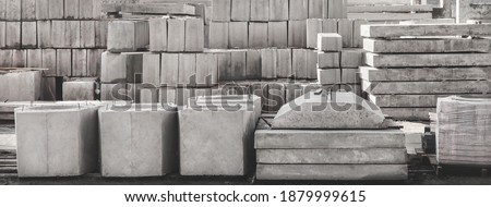 Storage of concrete blocks in a warehouse. Concrete structures at the construction site. Industrial, building materials Royalty-Free Stock Photo #1879999615