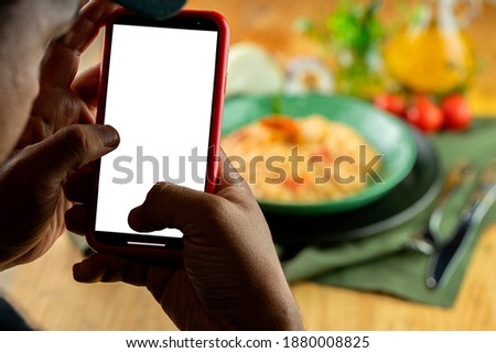 Person using a smartphone to take food picture