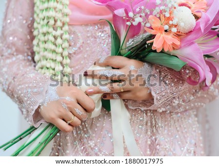 A bride's hand decorated with henna