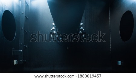 Ballast tank of a vessel with a pipe bolted to the bulkhead. Royalty-Free Stock Photo #1880019457
