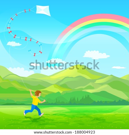 Boy running with a kite on a green meadow