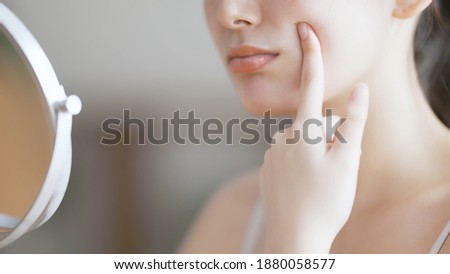 Young woman doing skin care Royalty-Free Stock Photo #1880058577