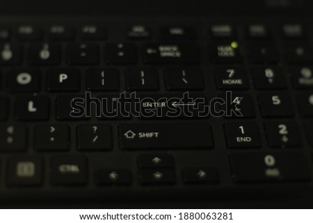 Concept of Business and Technology: Laptop keyboard with Focus on the Enter key to visualize a final step to enter the world