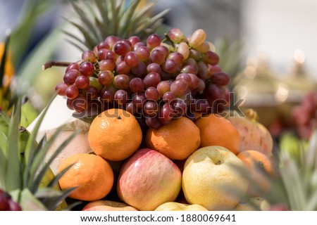 Various summer and autumn fruits. A grape and fruit  for pay respect to god. A grape for pay respect to the Buddha. fresh fruits mixed. Royalty-Free Stock Photo #1880069641