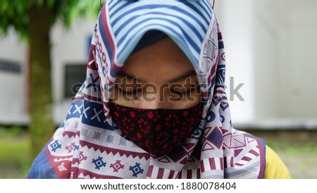 Stylish Muslim female hijab fashion lifestyle portraiture concept with face mask
