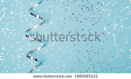 Photo border mock up wide image of light pastel  blue color background greeting card with silver garland and confetti