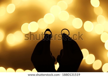 Wedding ring silhouette and Flashing light Bokeh