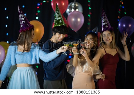 Happy Asian friends celebrating new year's eve 2021- people having fun together in patio home party - Winter and holidays concept