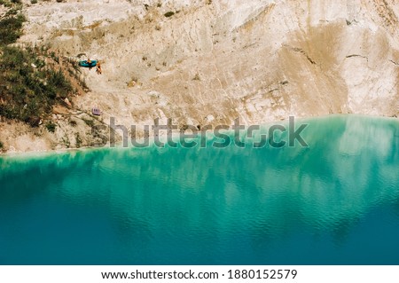 Vaukavysk chalk pits or Belarusian Maldives are beautiful saturated blue lakes.Two tourists pull a boat out of the water Belarus.
