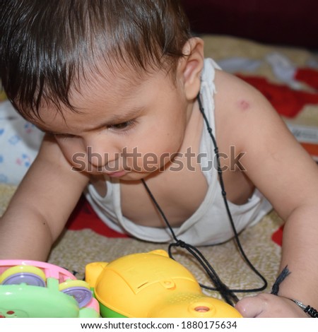 11 Month Baby Boy Indoors in Summer - stock photo, Cute Boy playing on the bed, Sweet Little baby boy enjoying during day time