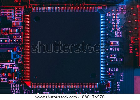 Hardware technology concept in neon light. Motherboard in blue-red light. Computer  component. Dark photo.Neon Colors.GPU processor. CPU Royalty-Free Stock Photo #1880176570