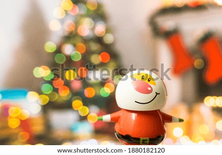 Adorable Santa Claus on a colorful Christmas tree lights and fireplace background