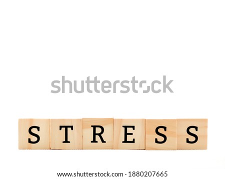 Wooden blocks alphabet "STRESS" isolated with white background.