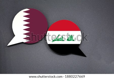 Qatar and Iraq flags with two speech bubbles on dark gray background