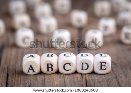 Wooden alphabet write; a, b, c, d, e