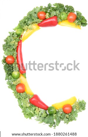 C shape letter made from vegetables high in vitamin C - kale, sweet peppers, chilli peppers, tomatoes and brussels sprouts on white background. Royalty-Free Stock Photo #1880261488