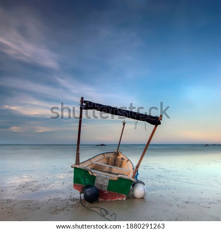 small  fishing boats near the beach located at Terengganu, Malaysia. long exposure shot. soft and grain effect.