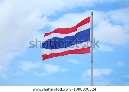 The flag of the Kingdom of Thailand Called THONG TRAI RONG, Meaning "Tricolour Flag" Waving on Blue Sky