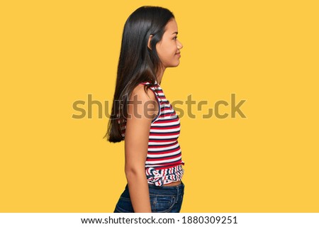 Beautiful hispanic woman wearing casual clothes looking to side, relax profile pose with natural face with confident smile. 