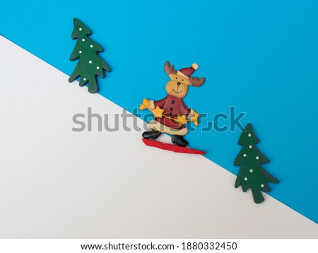 reindeer skiing downhill blue background and two 
