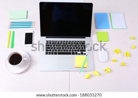Office workplace with open laptop on wooden desk