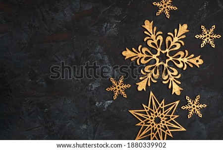 Christmas or New Year dark wooden background, Xmas black board framed with season decorations, space for a text. Christmas Background - Gold Snowflakes On dark background. Golden snowflakes. 