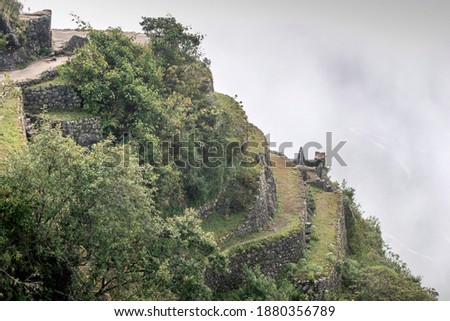 ancient Inca terraced fields on slope of Machu Picchu site in Peru