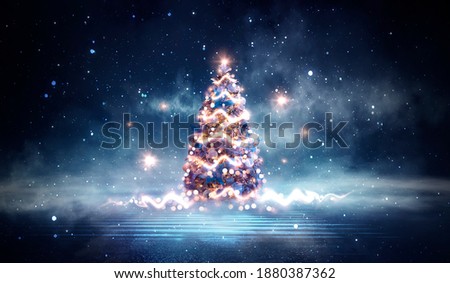 Night winter forest fantasy landscape with a Christmas decorated tree. Festive bokeh lights, dark forest, neon lights. Decorated Christmas tree in the night forest. Background for postcards.