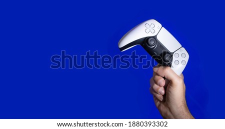 Next Gen game controller on mans hands Royalty-Free Stock Photo #1880393302