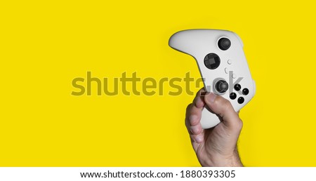 Next Gen game controller on mans hands Royalty-Free Stock Photo #1880393305