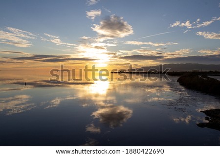 sunset with clouds in the water