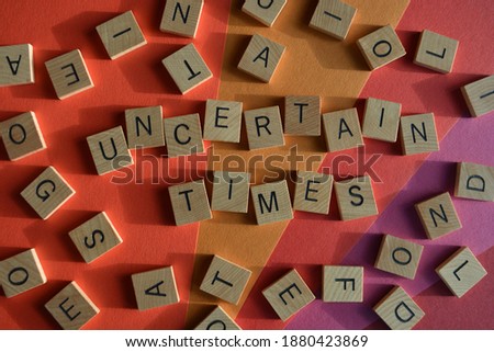 Uncertain Times, words surrounded by random alphabet letters Royalty-Free Stock Photo #1880423869