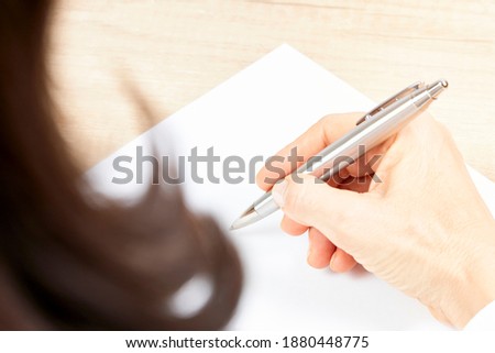 Business woman with a pen in her hand. International business concept. Signature.