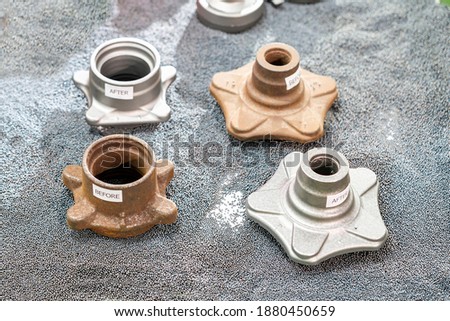 casting parts or work piece show before and after cleaning rust remove by shot blasting process put it on steel ball in box Royalty-Free Stock Photo #1880450659