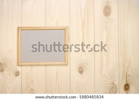 Mock up empty wood frame on light pine wood wall background, show text or product.