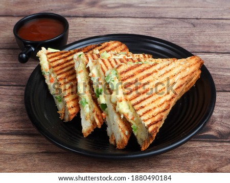 Veg grilled sandwich served with ketchup, isolated over a rustic wooden background, selective focus Royalty-Free Stock Photo #1880490184