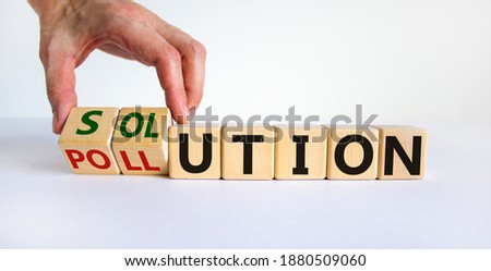 The solution to pollution symbol. Male hand flips wooden cubes and changes the word 'pollution' to 'solution'. Beautiful white background, copy space. Business, ecological and pollution concept.