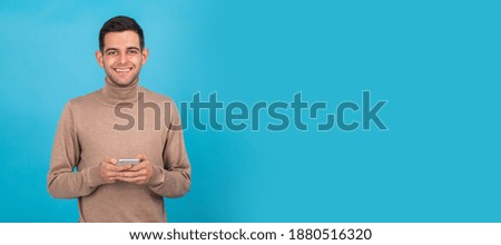 young man isolated on background with mobile phone or smartphone