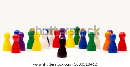 one stands out from others. wooden toys and a lonely pawn figurine. Concept of distinctive personality, social anxiety, social exclusion, bullying, depression, make fun of others, outsider and loner.