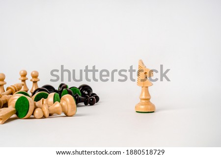 Chess battle of pieces of different colors on a white background, the concept of strategy and victory