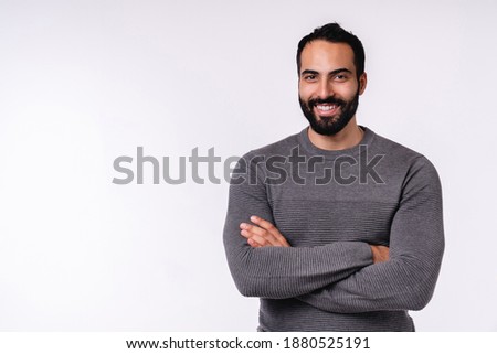 Confident smiling young arabian man in casual clothes isolated over white background Royalty-Free Stock Photo #1880525191